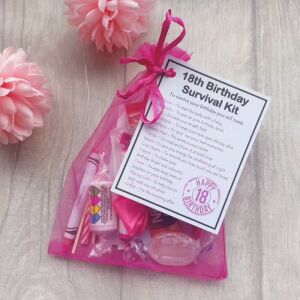 Pink 18th birthday survival kit in organza bag with laminated label explaining each symbolic item