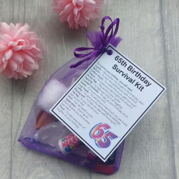 65th birthday novelty survival kit in organza bag with laminated label explaining humorous item descriptions