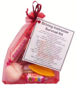 Driving Instructor Survival Kit in dark red organza bag with laminated label explaining each symbolic item