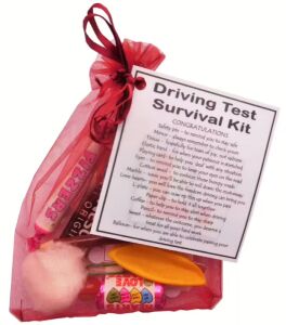 Driving Test Survival Kit in dark red organza bag with laminated label explaining each symbolic item for test day luck