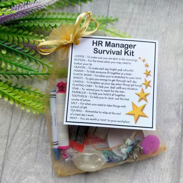 Hand-made HR manager survival kit in organza bag with laminated label showing humorous survival items for human resources professionals