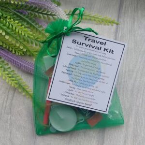 Travel Survival Kit in blue organza bag with laminated label showing novelty gift items for travellers